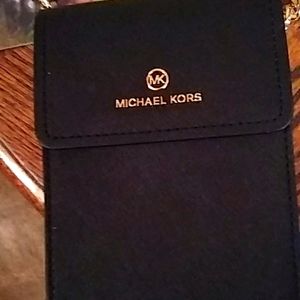 I'm selling a Michael Kors leather phone purse. It's brand new.